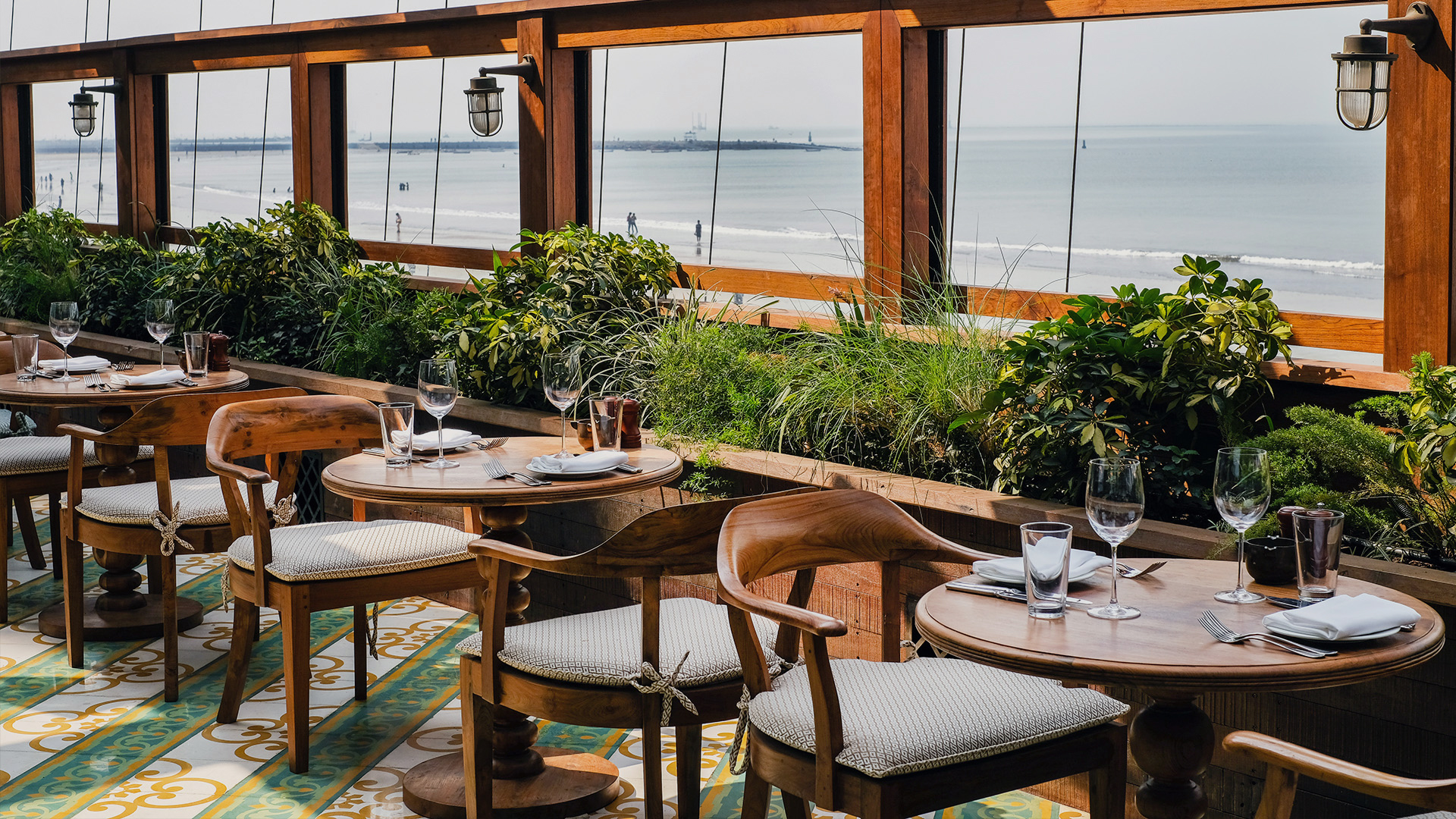 Mumbai City Guide | A row of tables in front of windows overlooking the windows in Mumbai, India