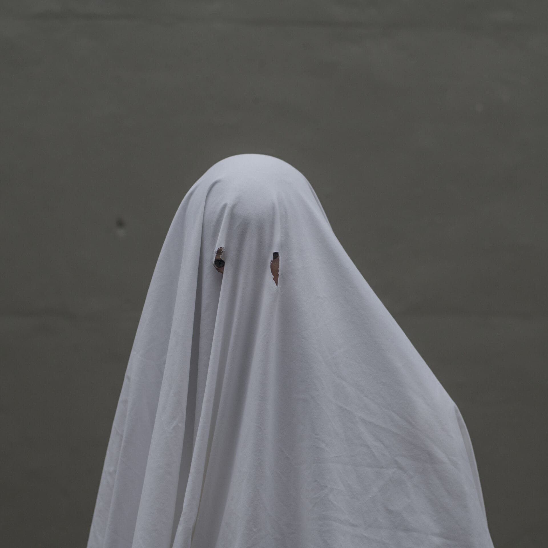 Photographer Rich-Joseph Facun | Someone wears a white bedsheet with two holes for eyes, like a ghost