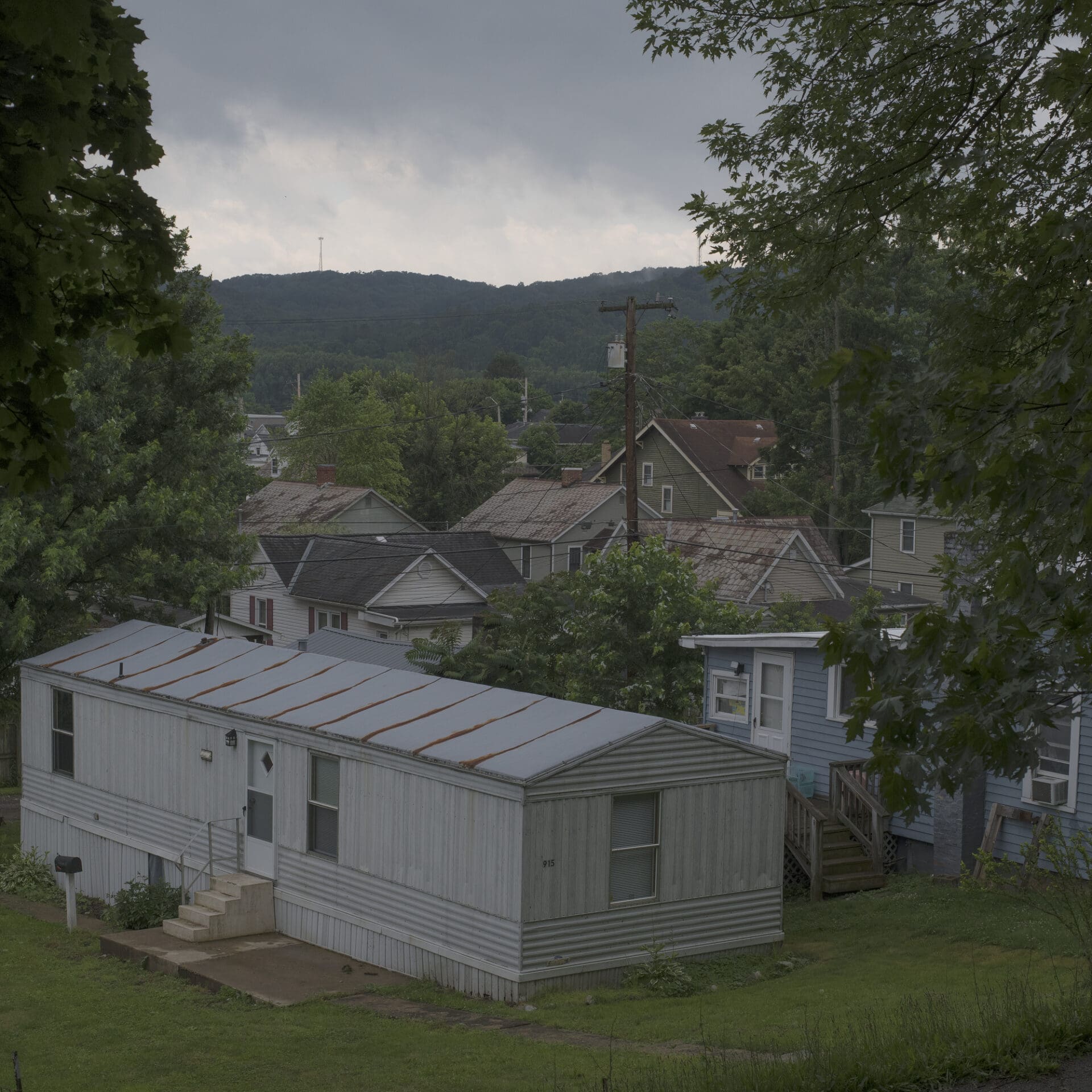 Photographer Rich-Joseph Facun | A view into Nelsonville in the Appalachian foothills, over a single-story whiteboard house and into the valley beyond