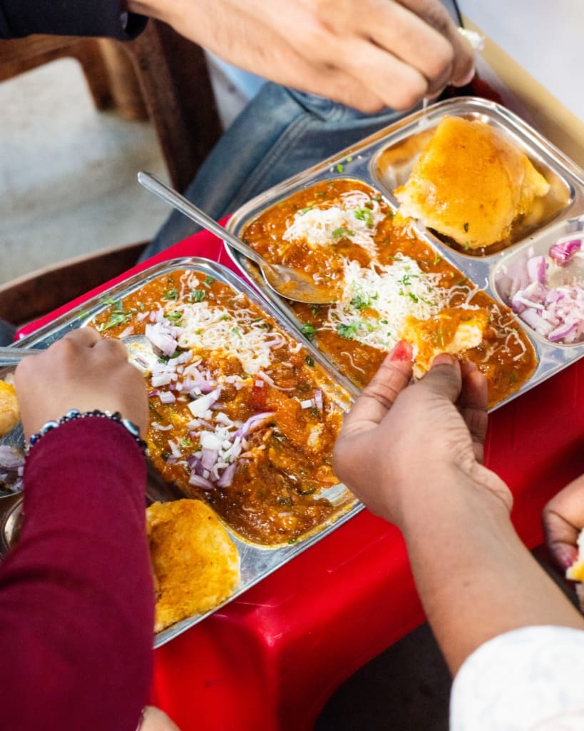 The best street food in Mumbai | Diners digging into Pav Bhaji at Lenin Pav Bhaji at the Marine Lines