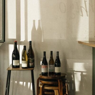 A view of wine bottles on stools at Hugo El Wine Bar