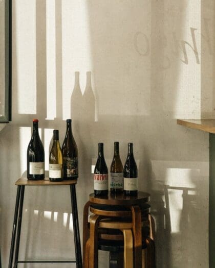 A view of wine bottles on stools at Hugo El Wine Bar