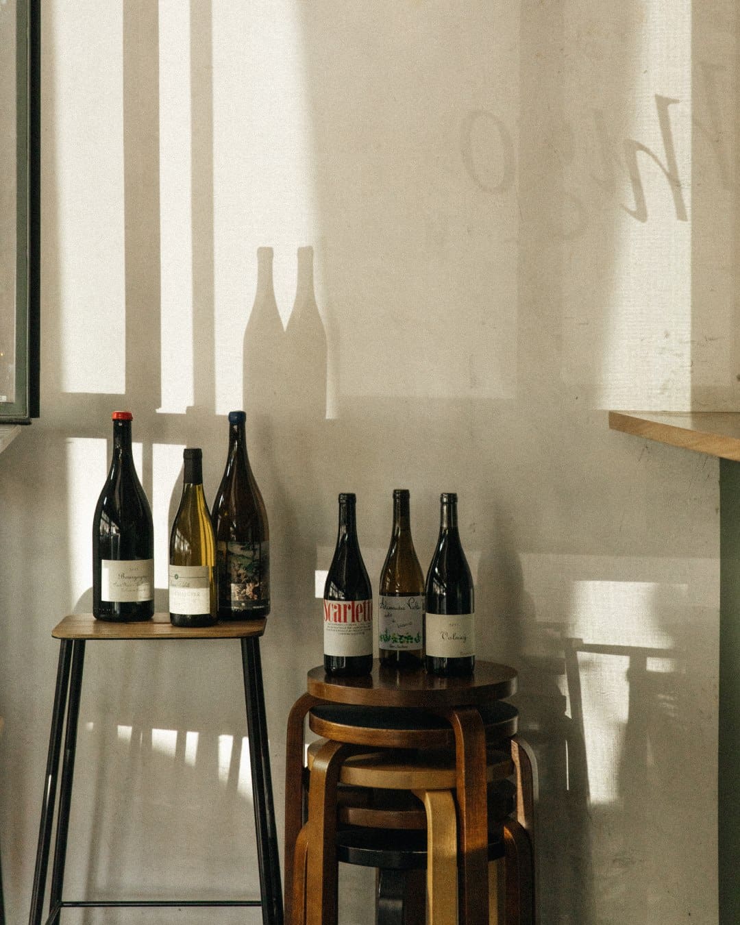 A view of wine bottles on stools at Hugo El Wine Bar