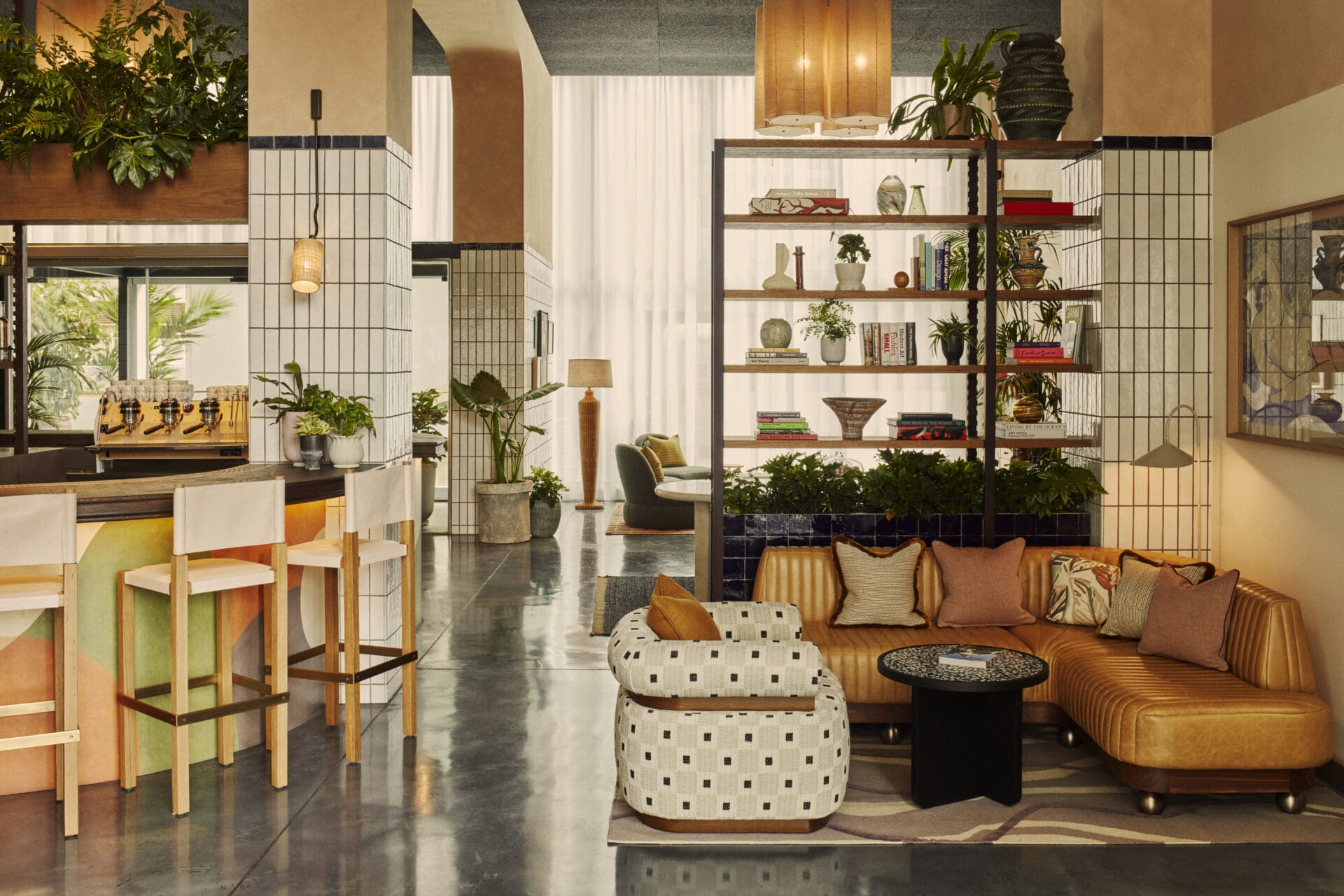 Best new hotels for summer 2022 | The Hoxton's new Barcelona opening has a communal space with concrete floors, tan leather low sofas and tiled walls, and square lampshades