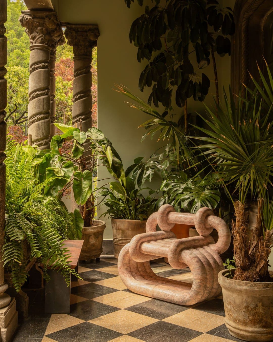 A plant-lined courtyard at Maison Lezard. Photography by Leandro Bulzzano