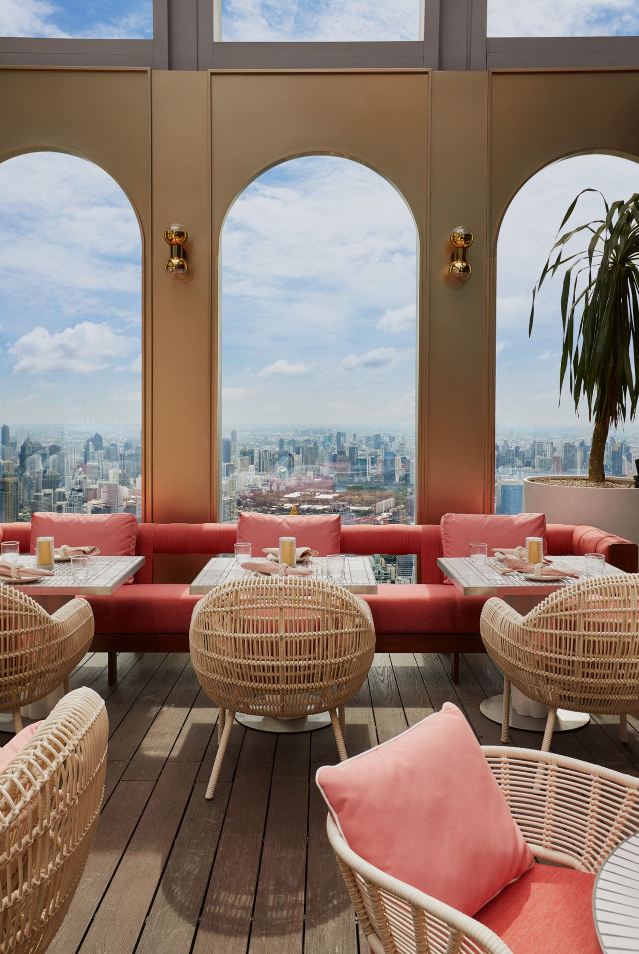 The Standard Bangkok Mahanakhon hotel opening | The terrace at Ojo, with gold accents, rattan furniture and views over the city