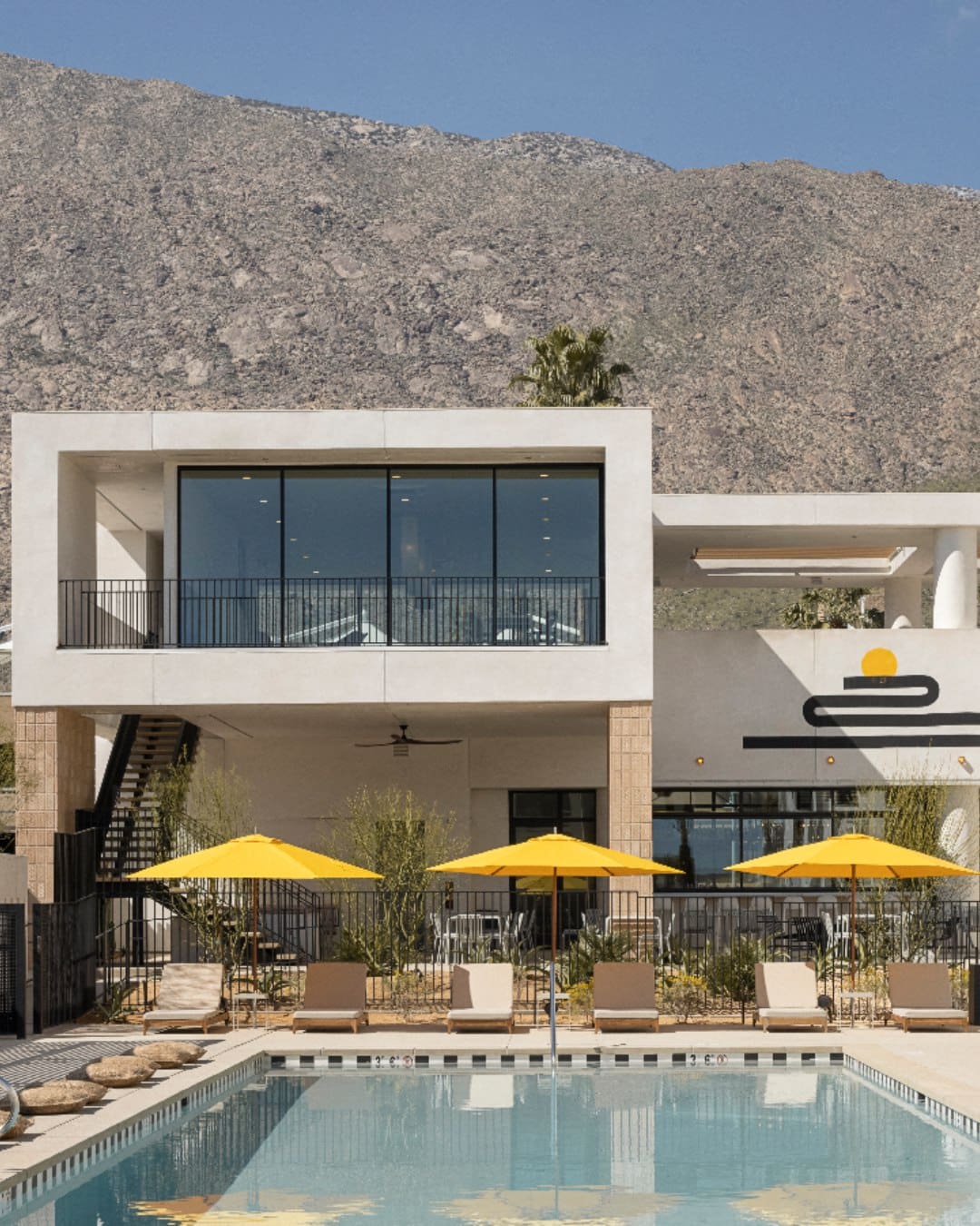 Yellow parasols pop against white angular architecture at Drift Palm Springs