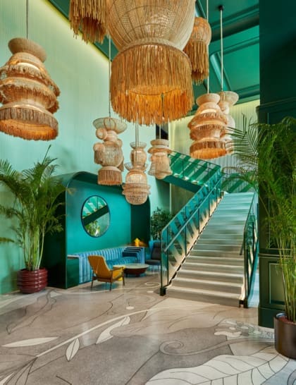 The Standard Bangkok Mahanakhon hotel opening | the lobby space, with green walls and hanging rattan lampshades