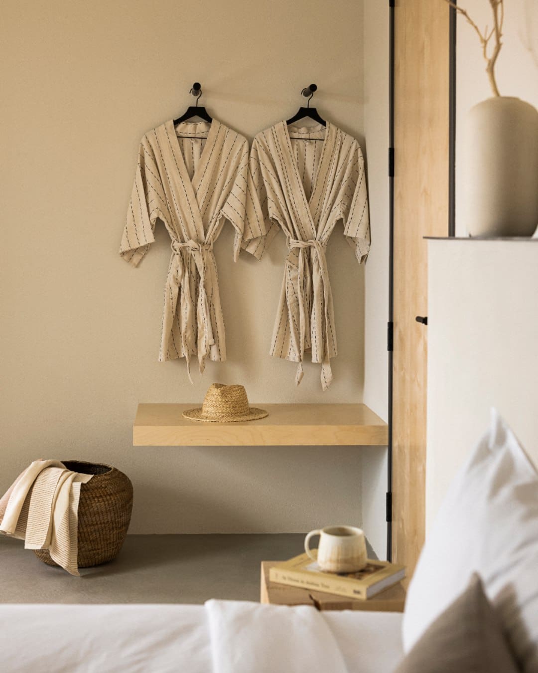 Robes hang on a wall in neutral shades at Drift Palm Springs