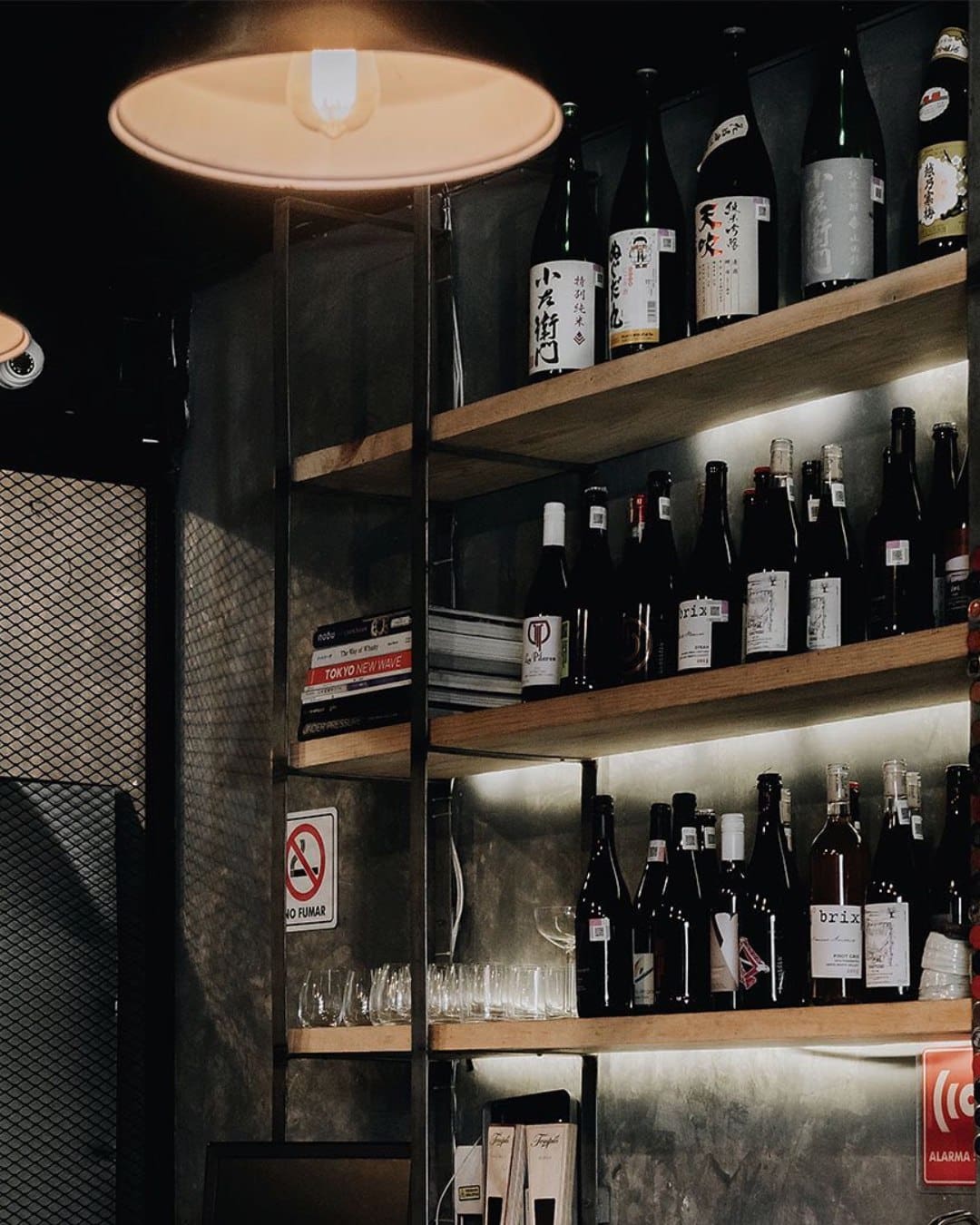 Bottles lined on a shelf at Le Tachinomi Desu, a Japanese-style standing bar