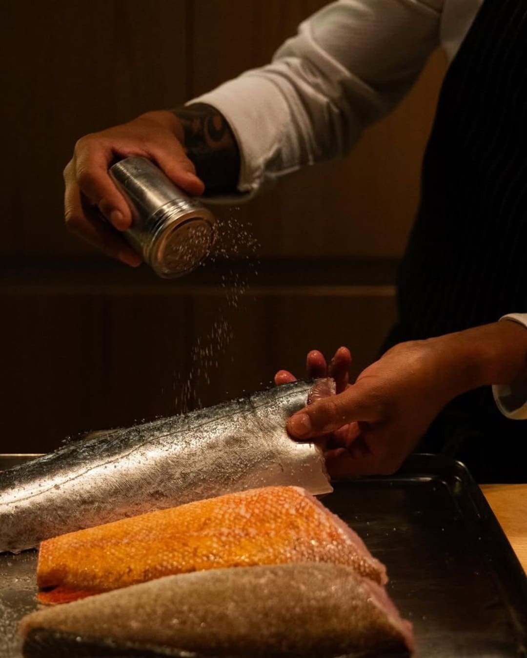 A chef preparing fish at Sushi Kyo