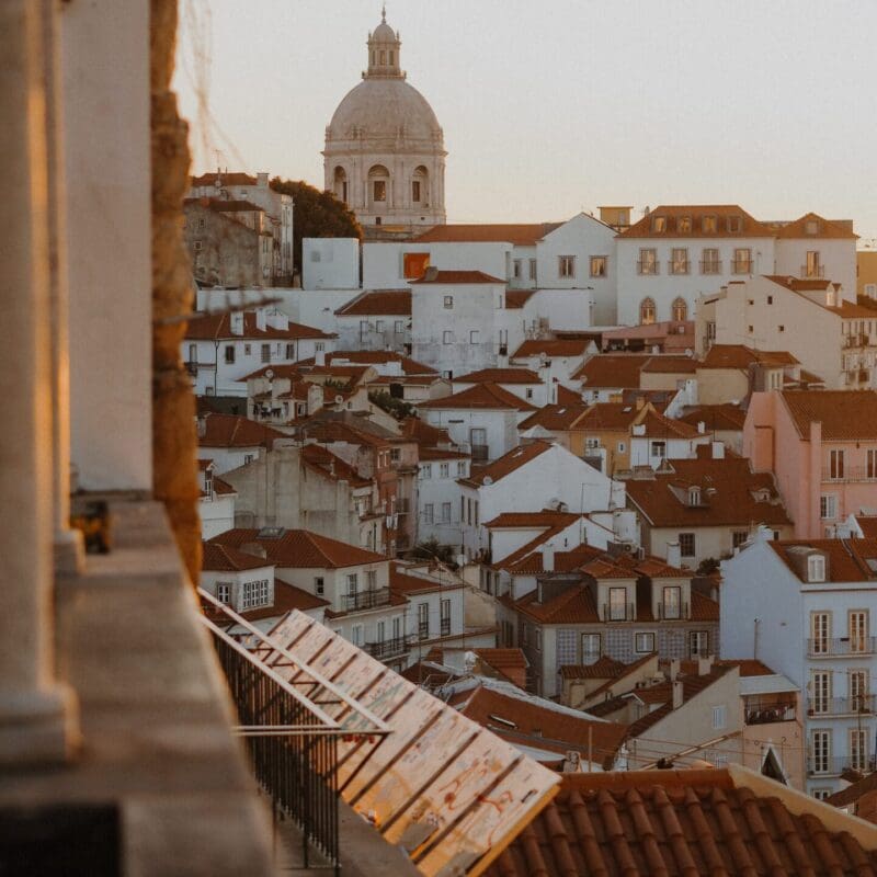 The best European cities for remote working | A view of the terracotta rooftops of Lisbon at sunrise