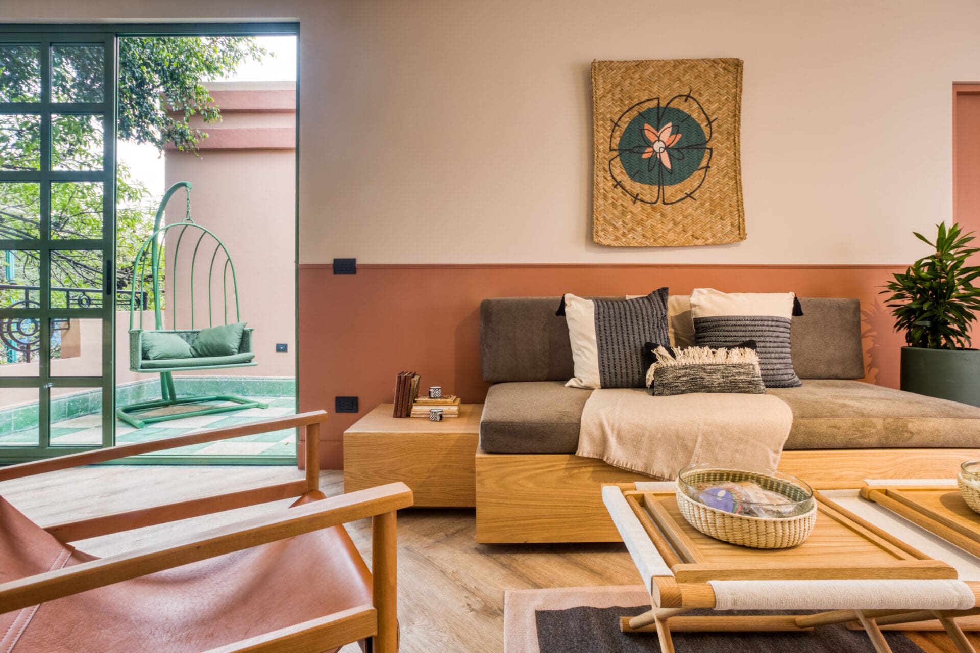 The best hotels in Mexico City | An interior view of a sitting room in Casa Oliva, with crittal doors opening to an outdoor terrace.