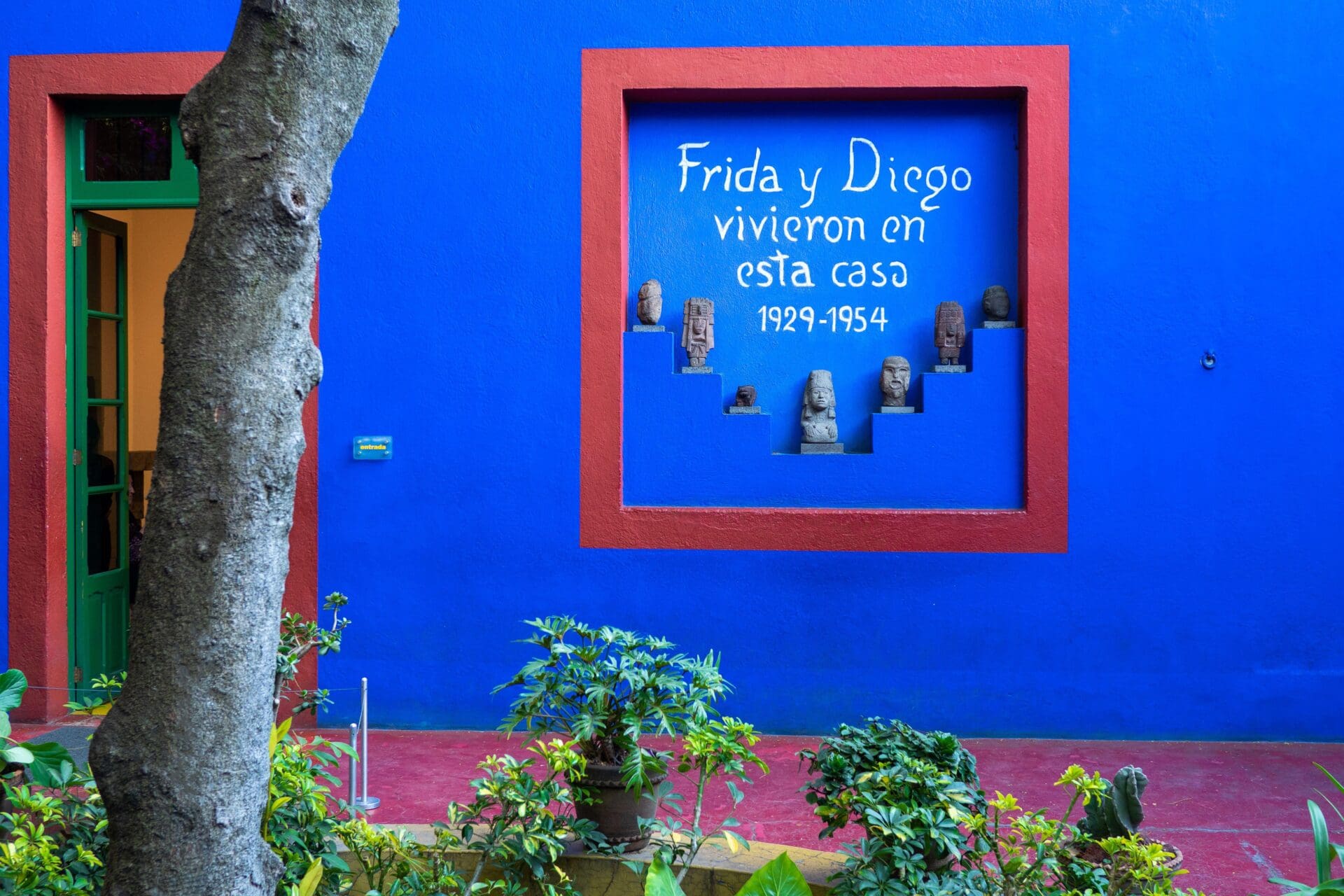 Best museums and galleries Mexico City | A sign outside Frida's Kahlo's blue house, with a red border around the blue wall and white writing