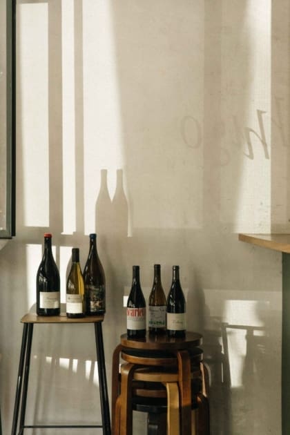 The best bars in Mexico City | A view of wine bottles on stools at Hugo El Wine Bar