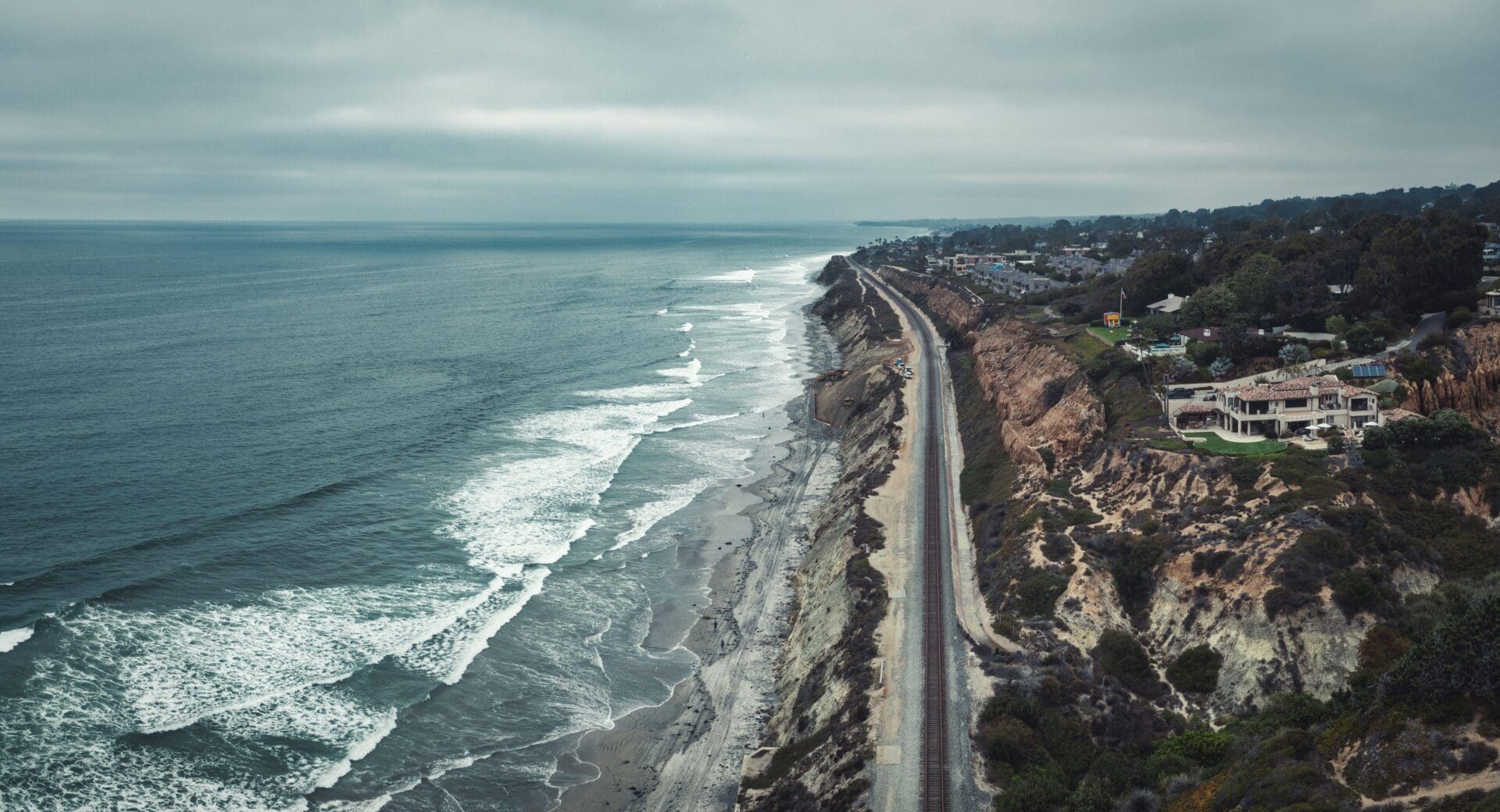 Travelling LA to San Francisco via Amtrak train | The train tracks hugging the rugged California coastline in Del Mar, travelling along stormy seas