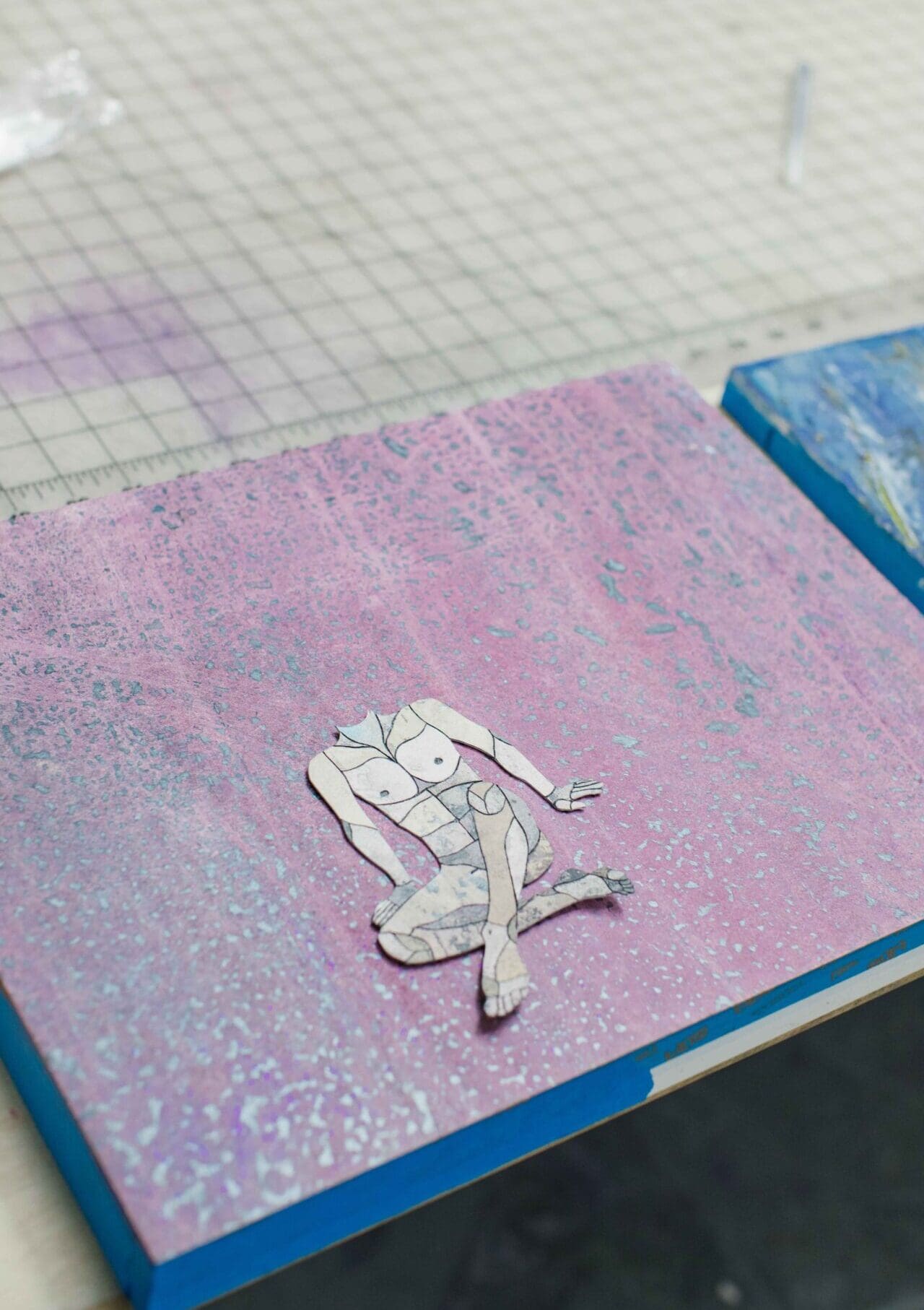 Felipe Baeza | A small collage work of a sitting torso on a purple block inside Felipe Baeza's studio