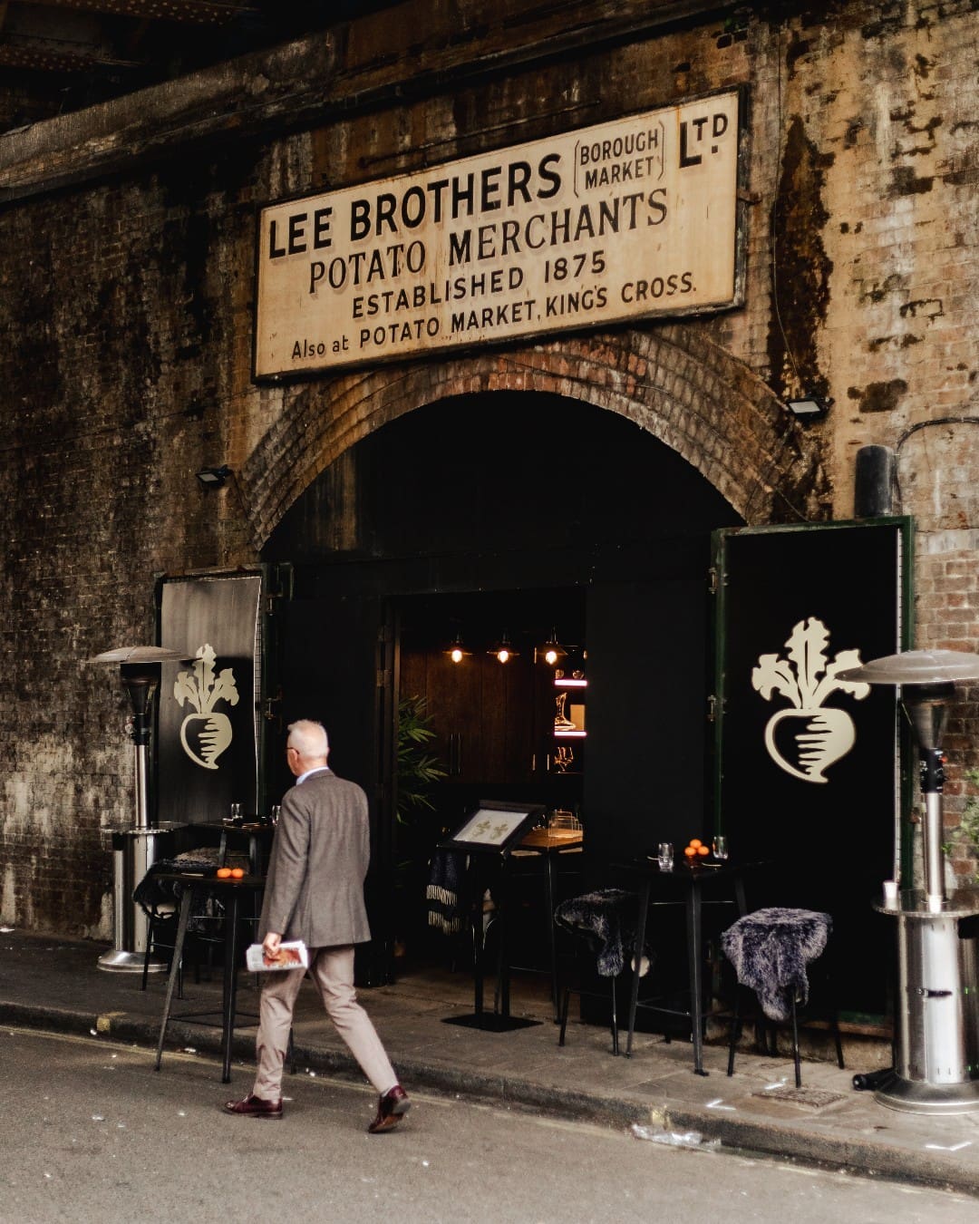 Best London Bridge and Borough Restaurants | Man walks alongside the front doors of Turnips Restaurant