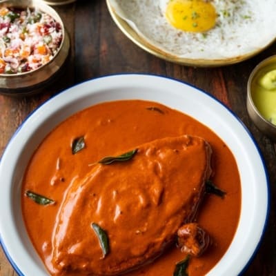 The best restaurants in Bandra, Mumbai | A red tamarind fish curry in a bowl on a wooden tabletop