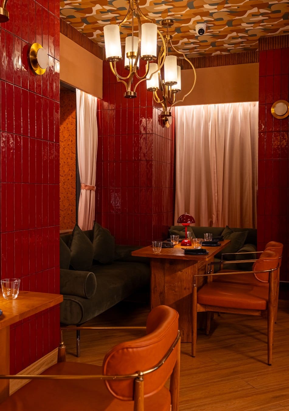 Tables and chairs in earthy tones at HOM in Mumbai.