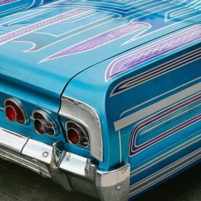 Photographer Manuel Zúñiga on Mexico City | the rear corner and boot of a classic car, with blue and purple patterns.