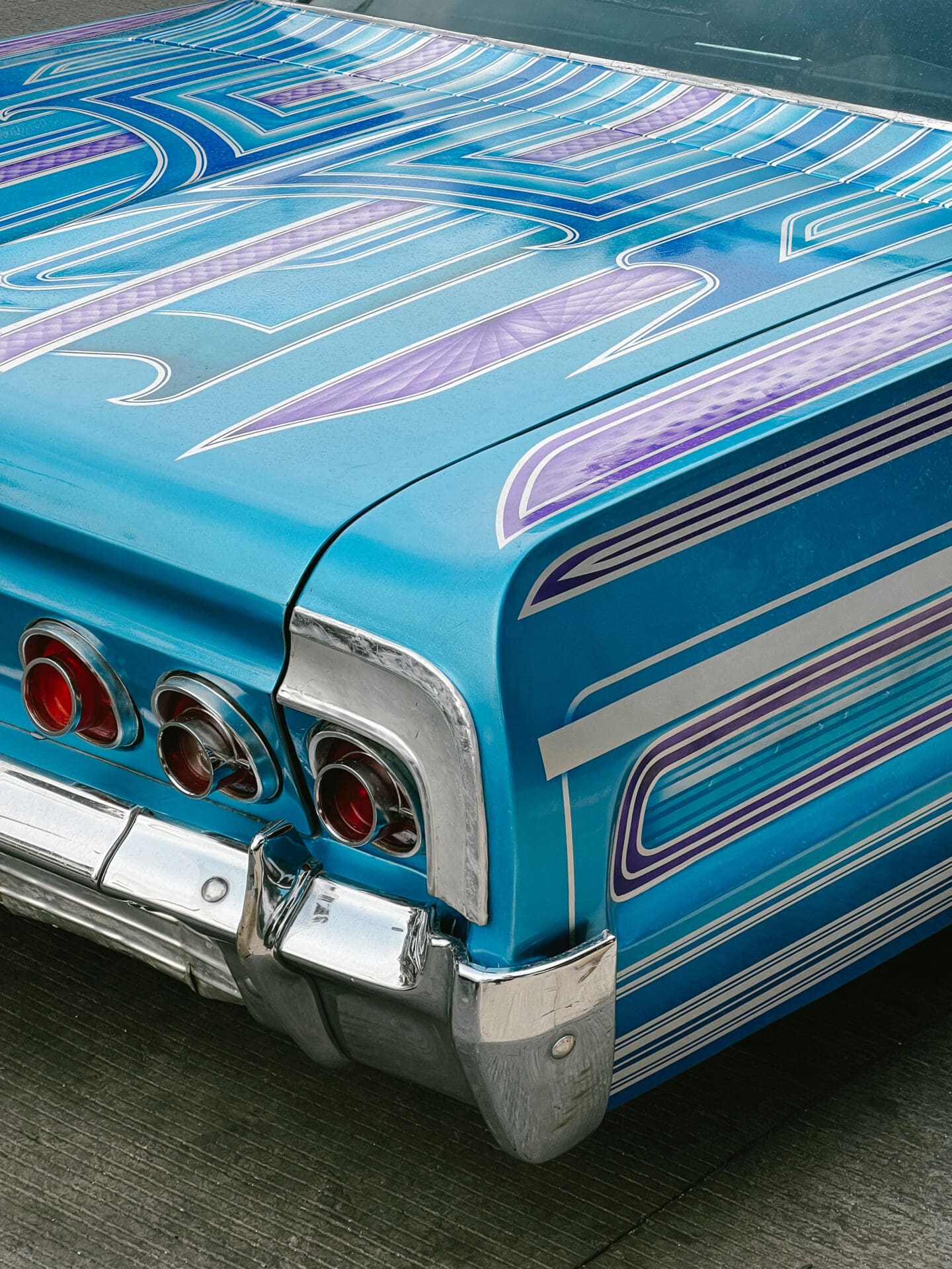 Photographer Manuel Zúñiga on Mexico City | the rear corner and boot of a classic car, with blue and purple patterns.