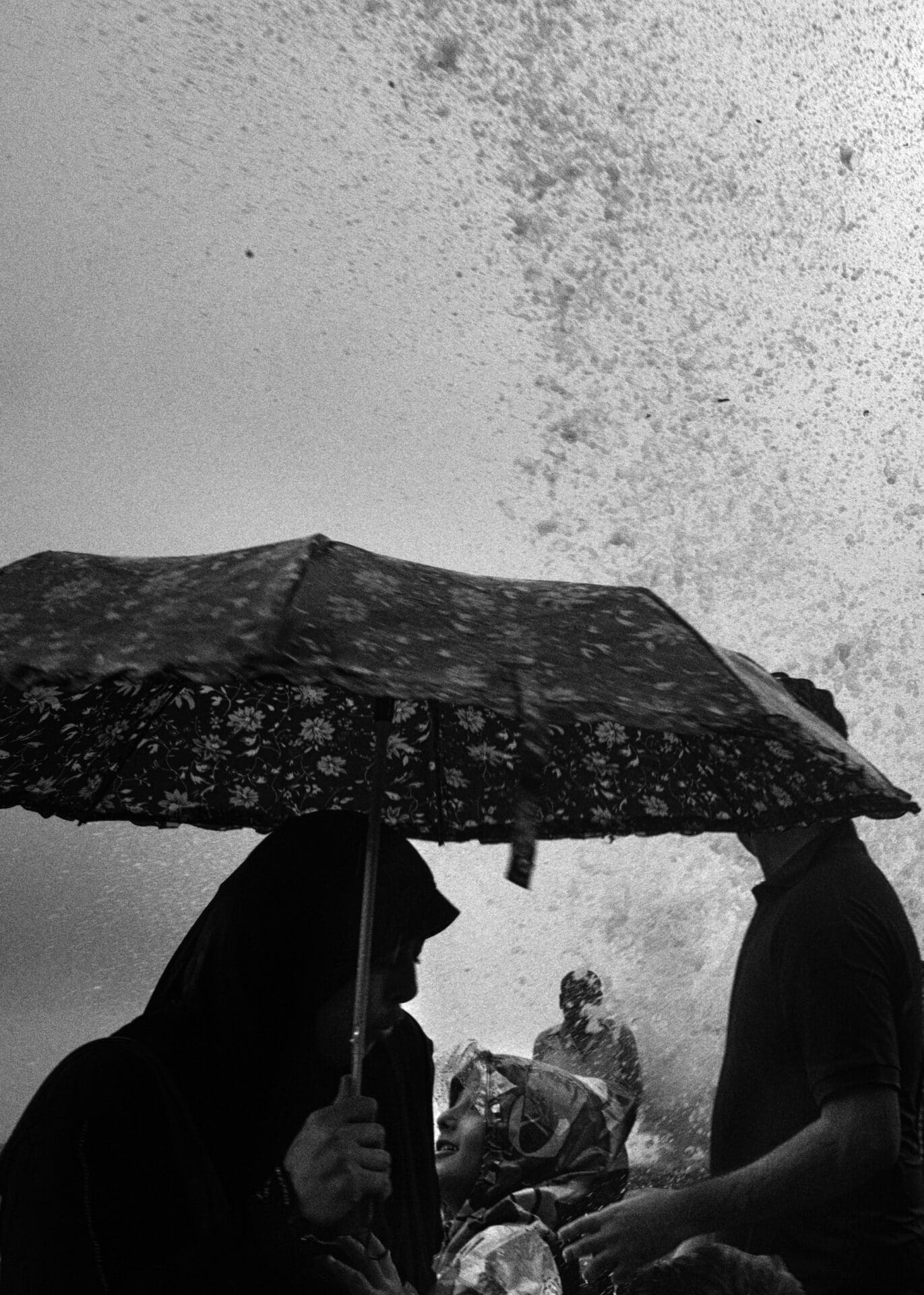 Photographer Sunhil Sippy on Mumbai | someone holds a patterned umbrella to shield against sea spray