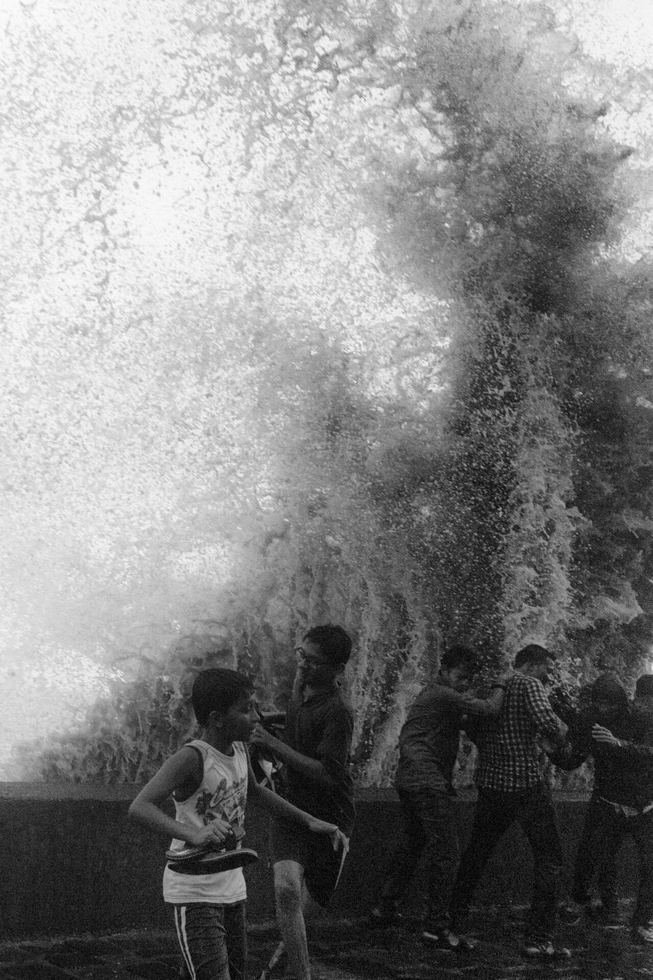 Photographer Sunhil Sippy on Mumbai | children in front of a sea wall as a huge wave breaks