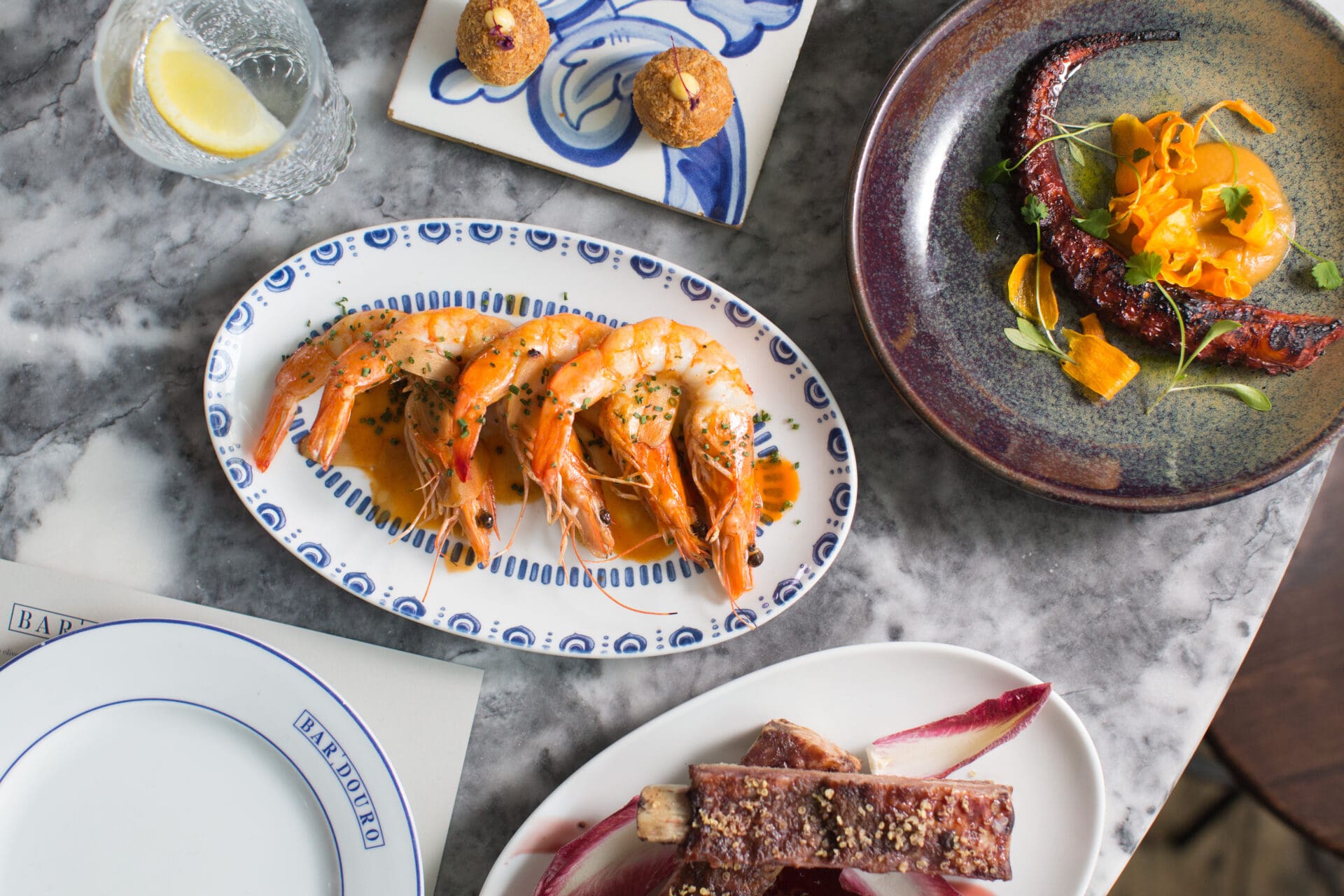 Best restaurants in London Bridge and Borough | A plate of prawns, a curl of octopus and some croquettes served on a blue-and-white tile