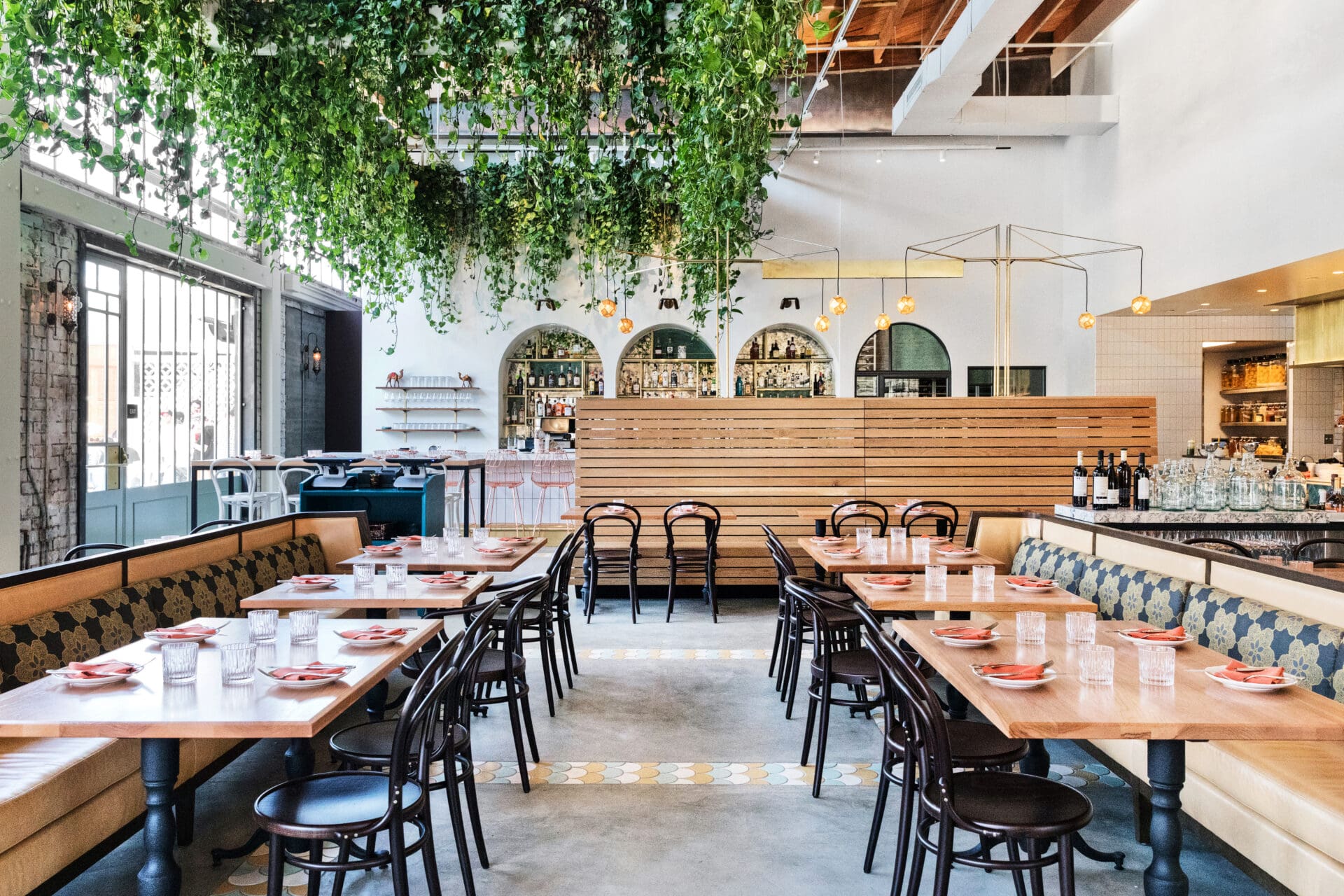 Best restaurants LA Arts District | The interiors at Bavel, with white marble floors, wood-topped tables and hanging greenery in a bright, airy space