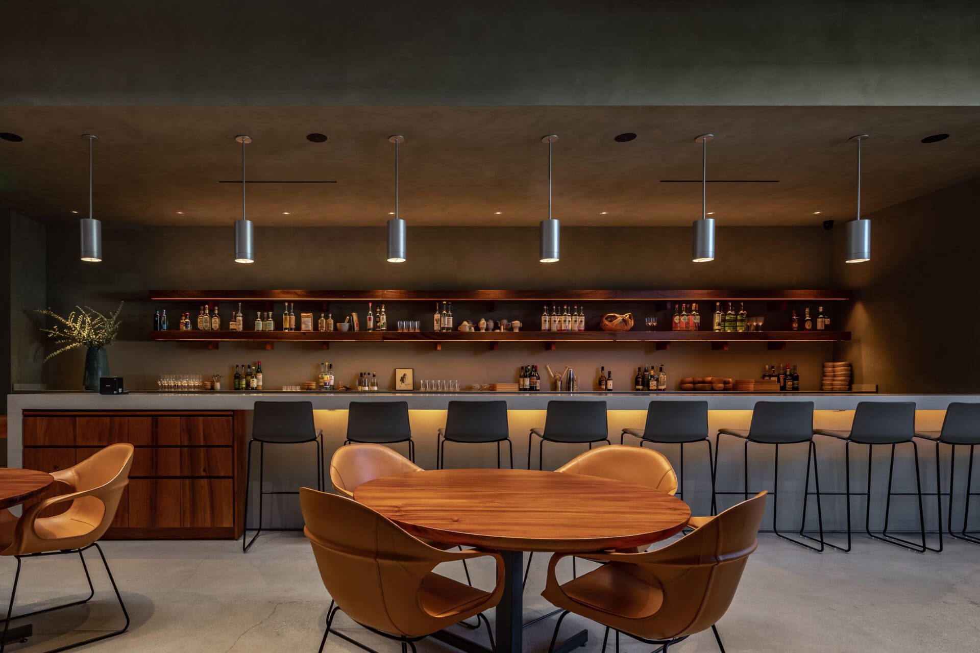 Best restaurants LA Arts District | Muted interiors with round wooden tables at Damian