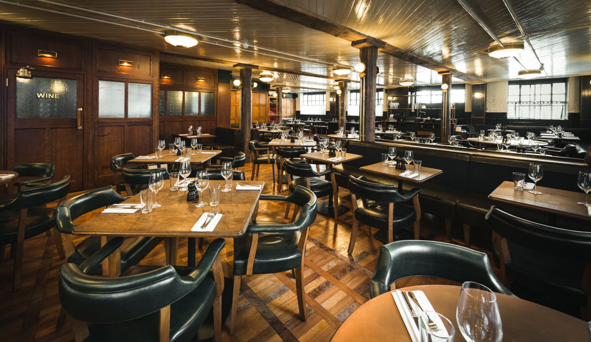 Best restaurants in London Bridge and Borough | wooden and leather interiors in the downstairs dining room at Hawksmoor Borough