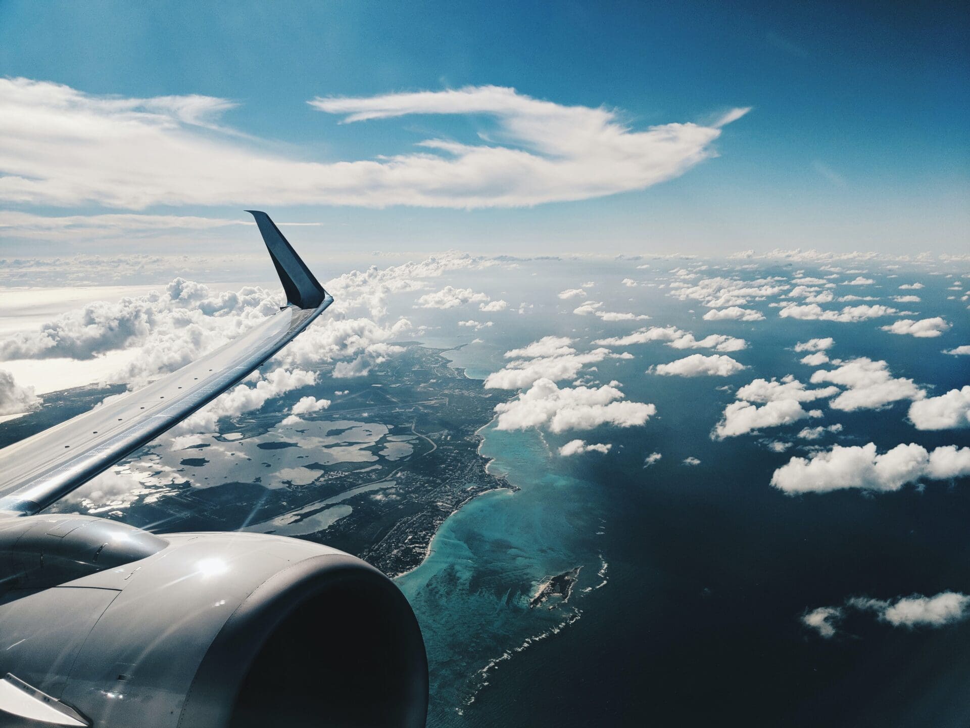 Airline news and trends | A view from an airplane window over the wing and a lightly clouded sky