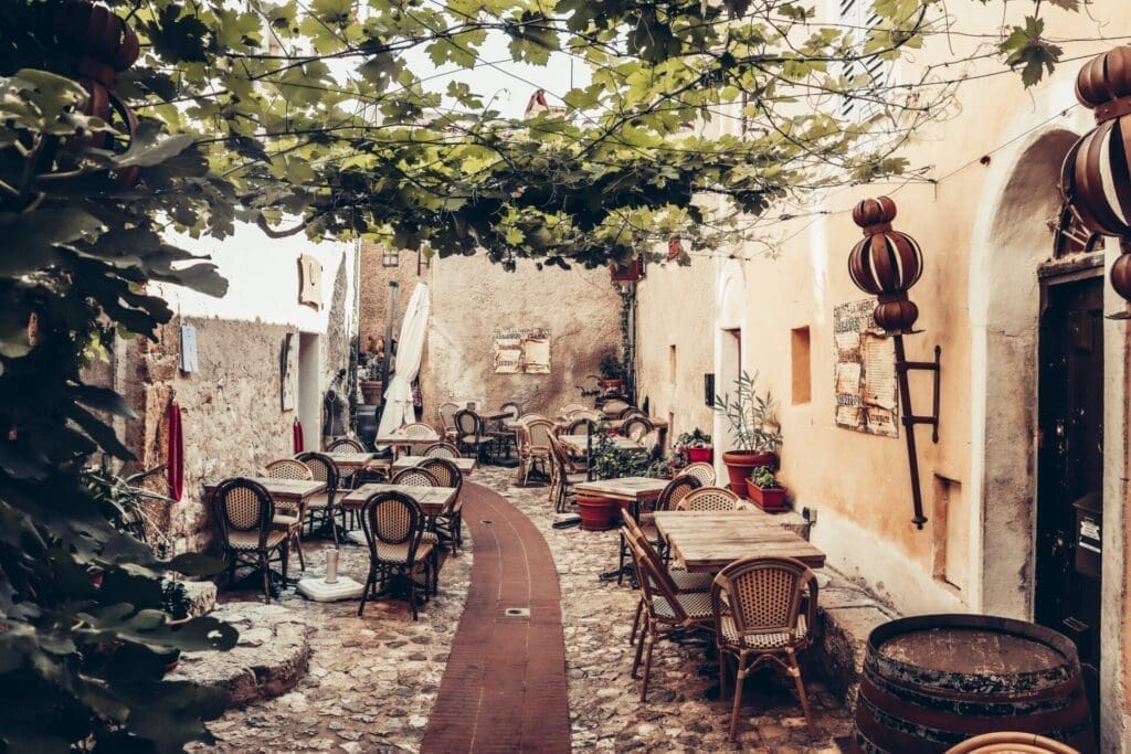 Running in Nice | A restaurant down one of Éze's cobbled side streets, with classic French-style wicker chairs