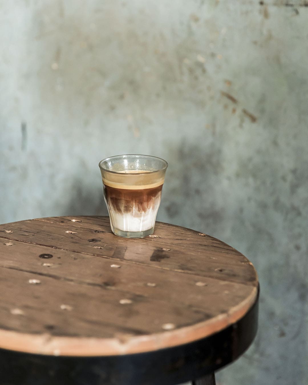 A 'Dirty Coffee' on a wooden table at Sarnies in Bangkok