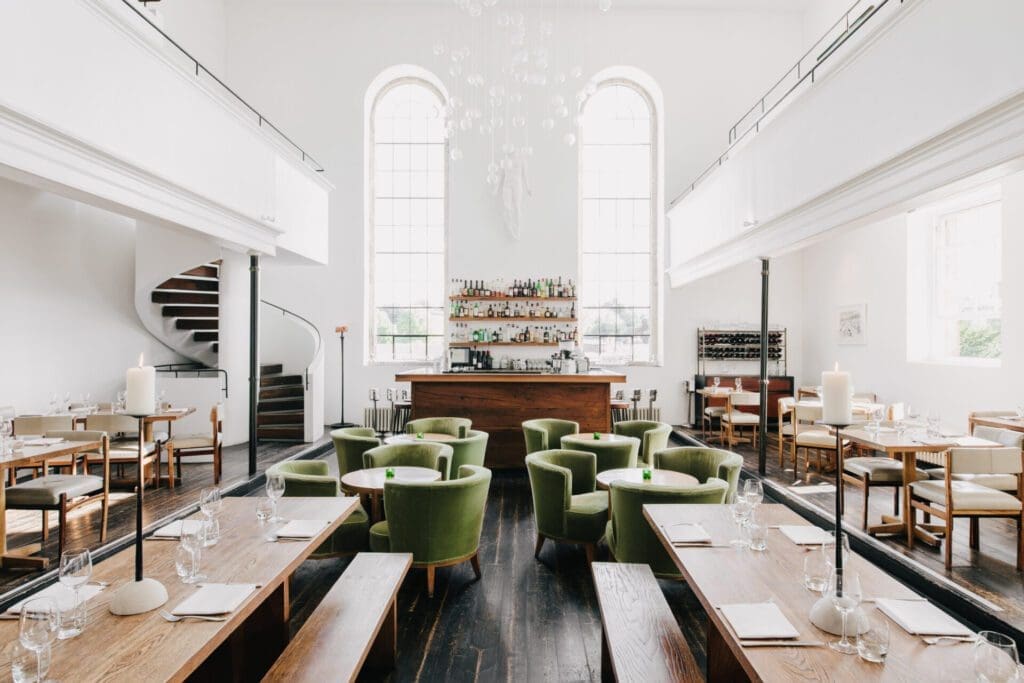 The best restaurants in Bruton | At The Chapel, light-filled dining room with table set against white walls