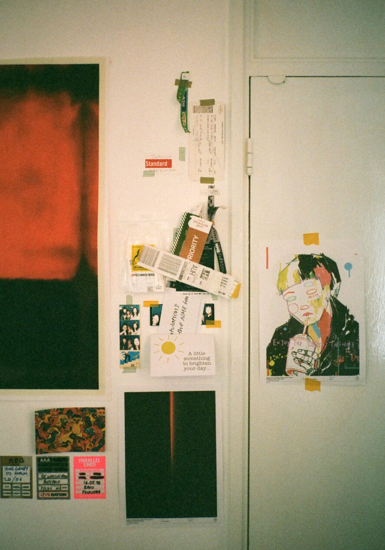 An interview with Thai pop singer Pyra | A wall in Pyra's apartment with photos, tickets, and posters tacked to the white wall.