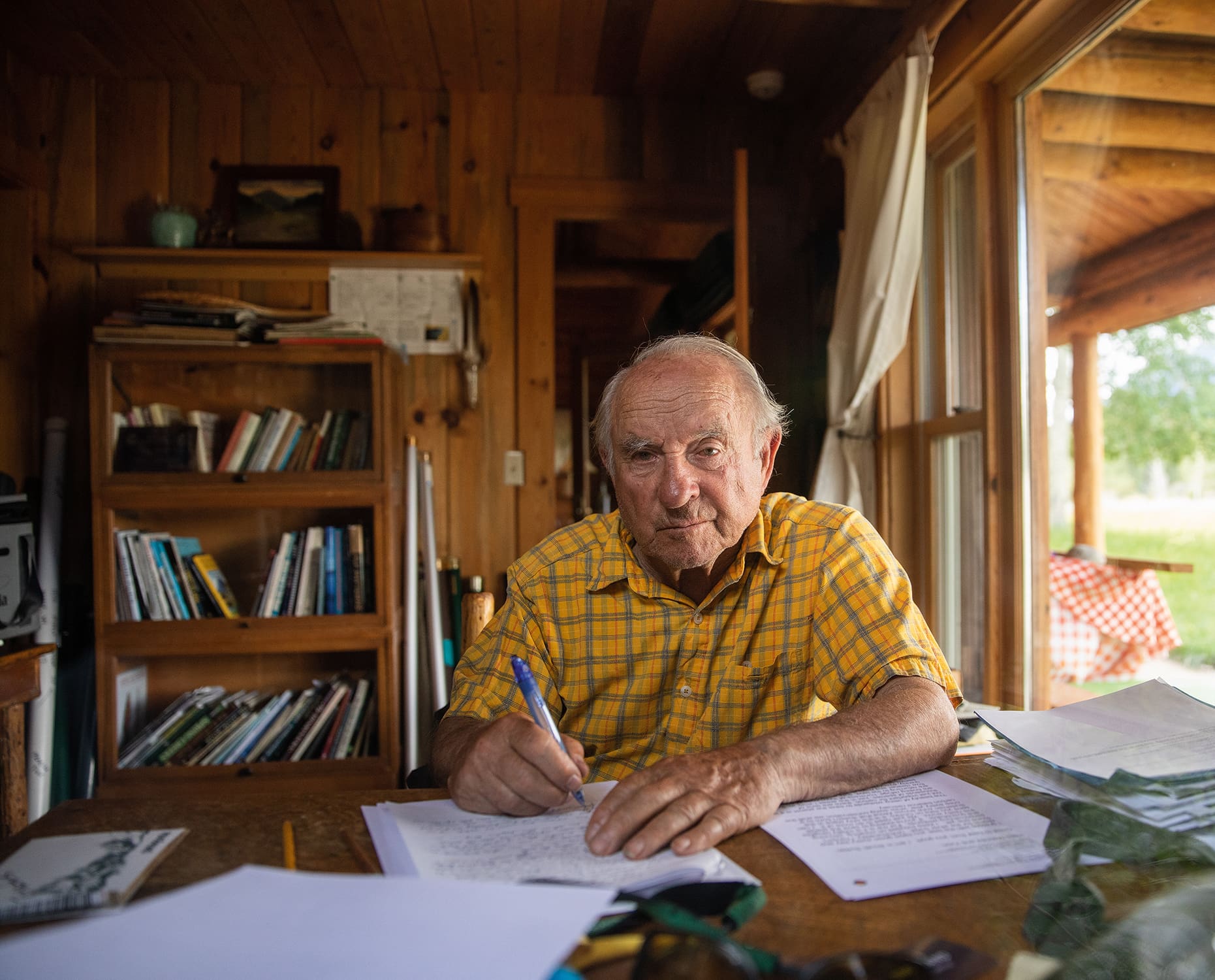 Patagonia founder Yvon Chouinard sits at his desk in his wood-clad office