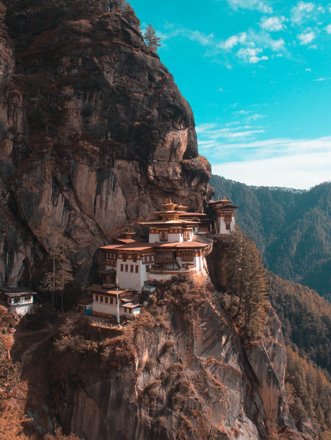 Bhutan reopens its borders | Paro Taktsang in Bhutan, etched on a cliffside beneath a bright blue sky