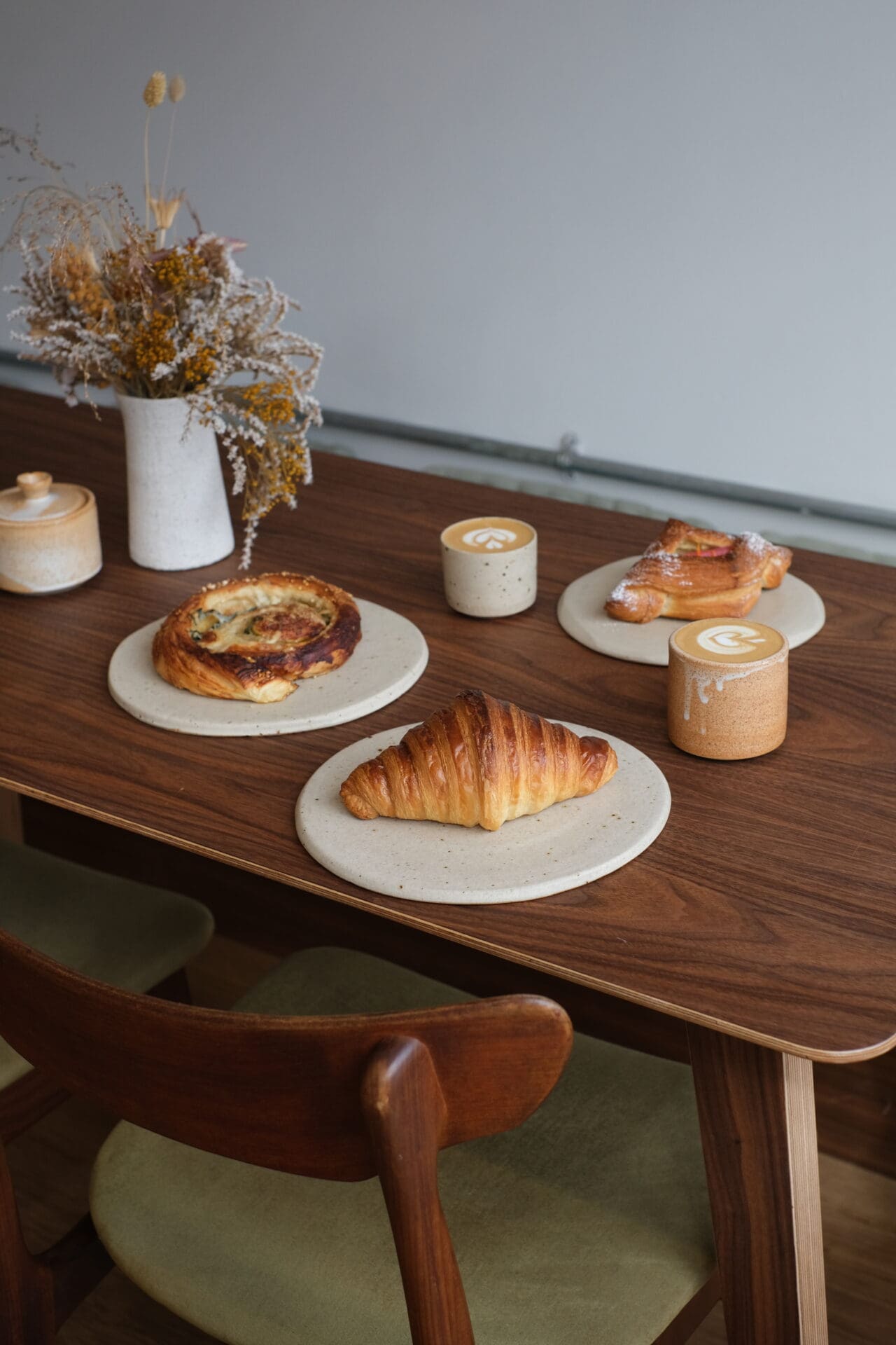 Pastries and coffee on a wooden table at Popham's, one of the best bakeries in London