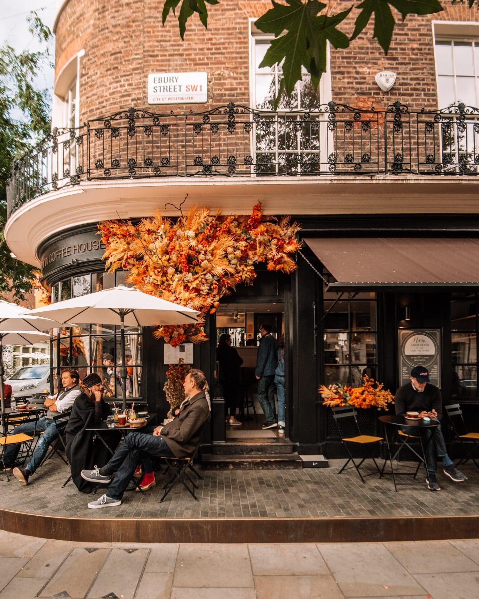 The floral facade and outdoor seating at Tomtom Coffee House in Belgravia, London
