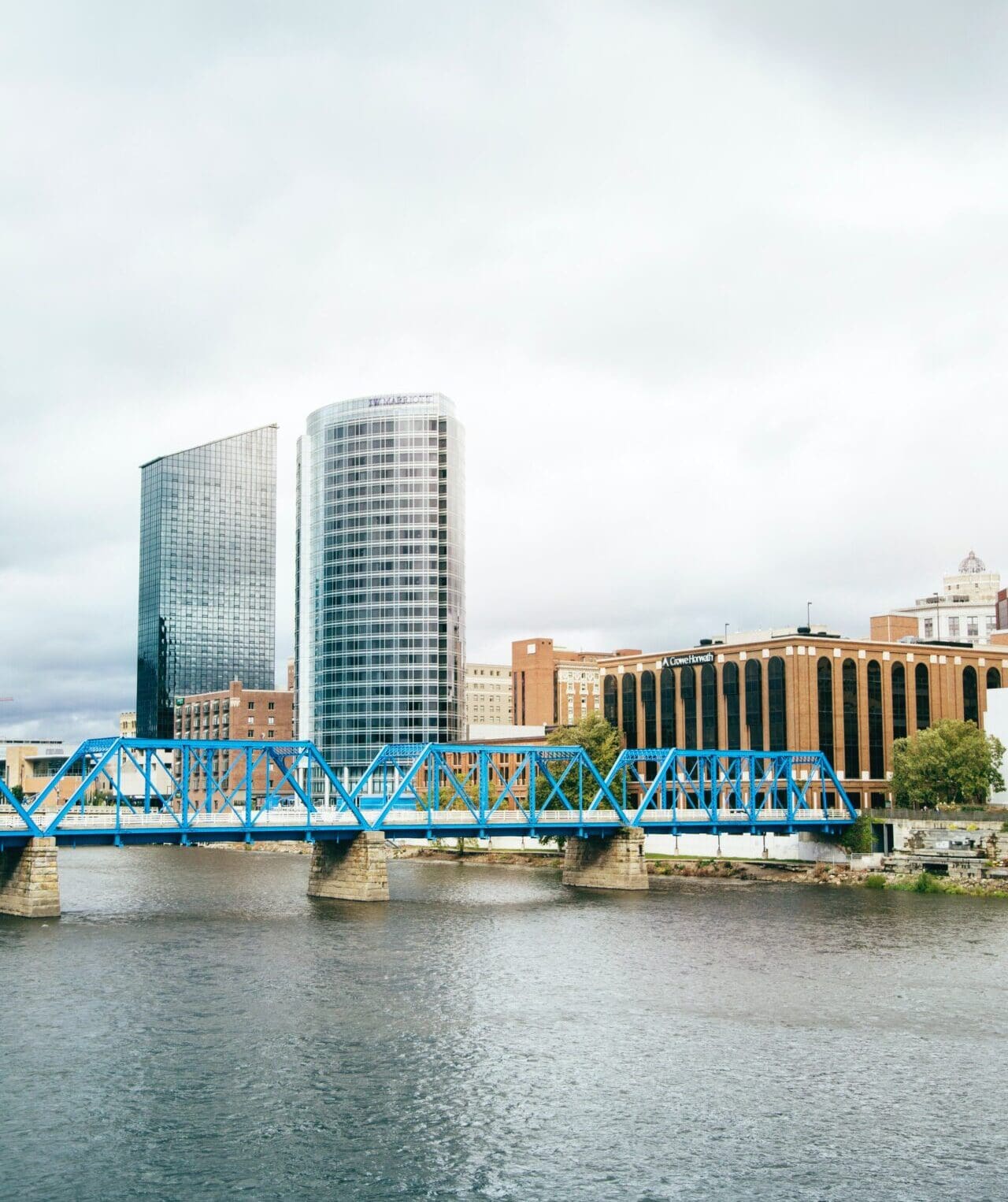 A blue bridge against industrial skyscrapers in Grand Rapids, Michigan
