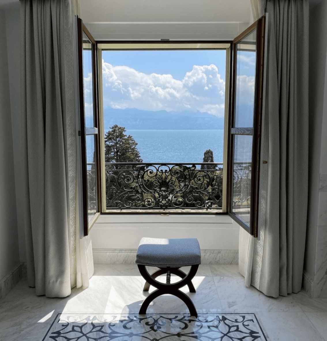 Rail holiday along the shores of Lake Geneva | Window looking over the lake at Beau-Rivage Palace in Lausanne on Lake Geneva