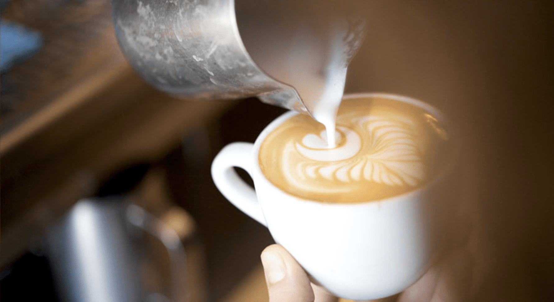 The best coffee shops in London | A flat white being poured at Flat White cafe