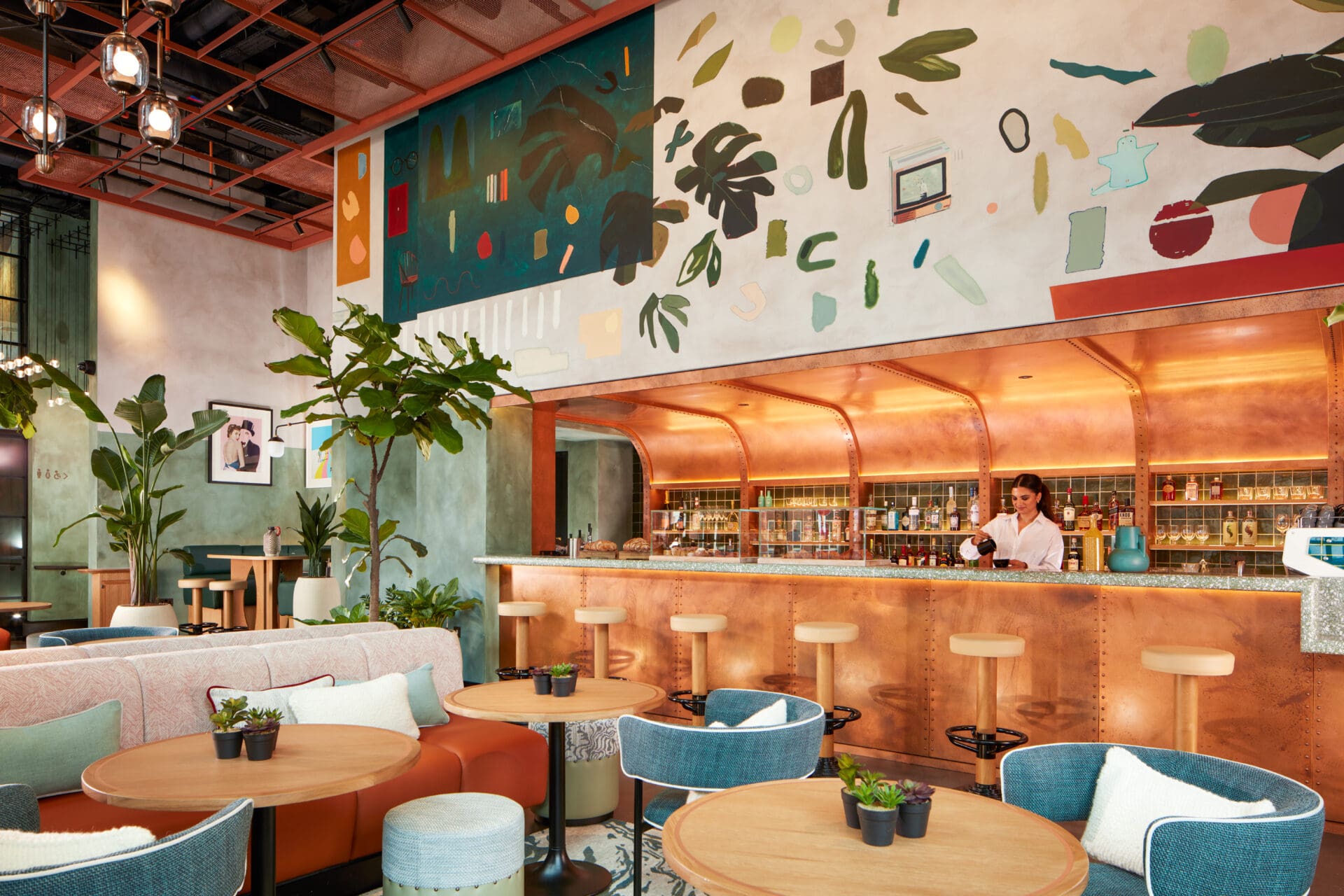 The copper bar at the Mondrian Shoreditch hotel, flanked by indoor greenery