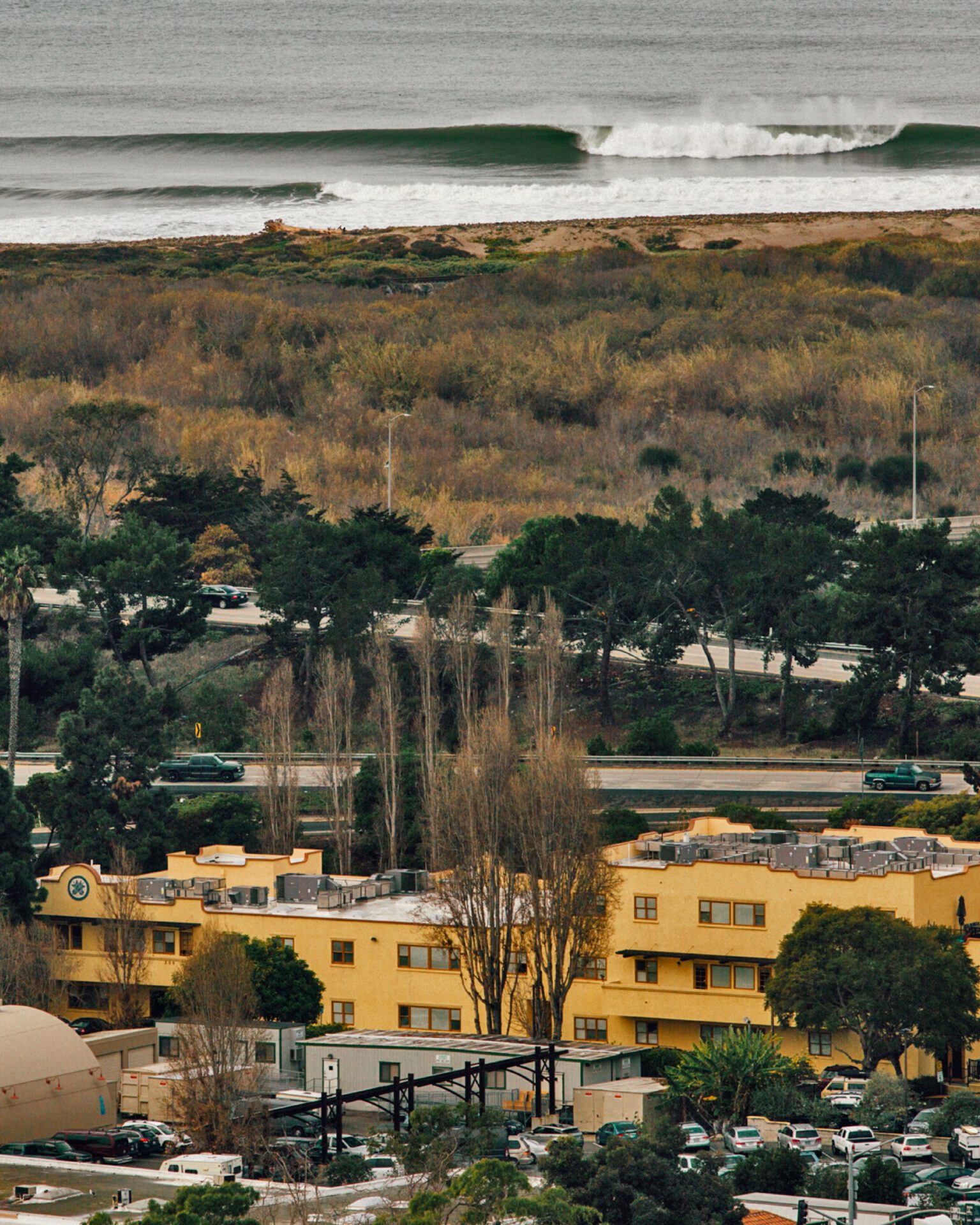 The Patagonia Campus in Ventura, California | yellow tone buildings, trees and cars
