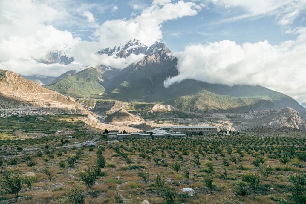 A rural view of Shinta Mani Mustang in Nepal beneath clouds and a blue sky