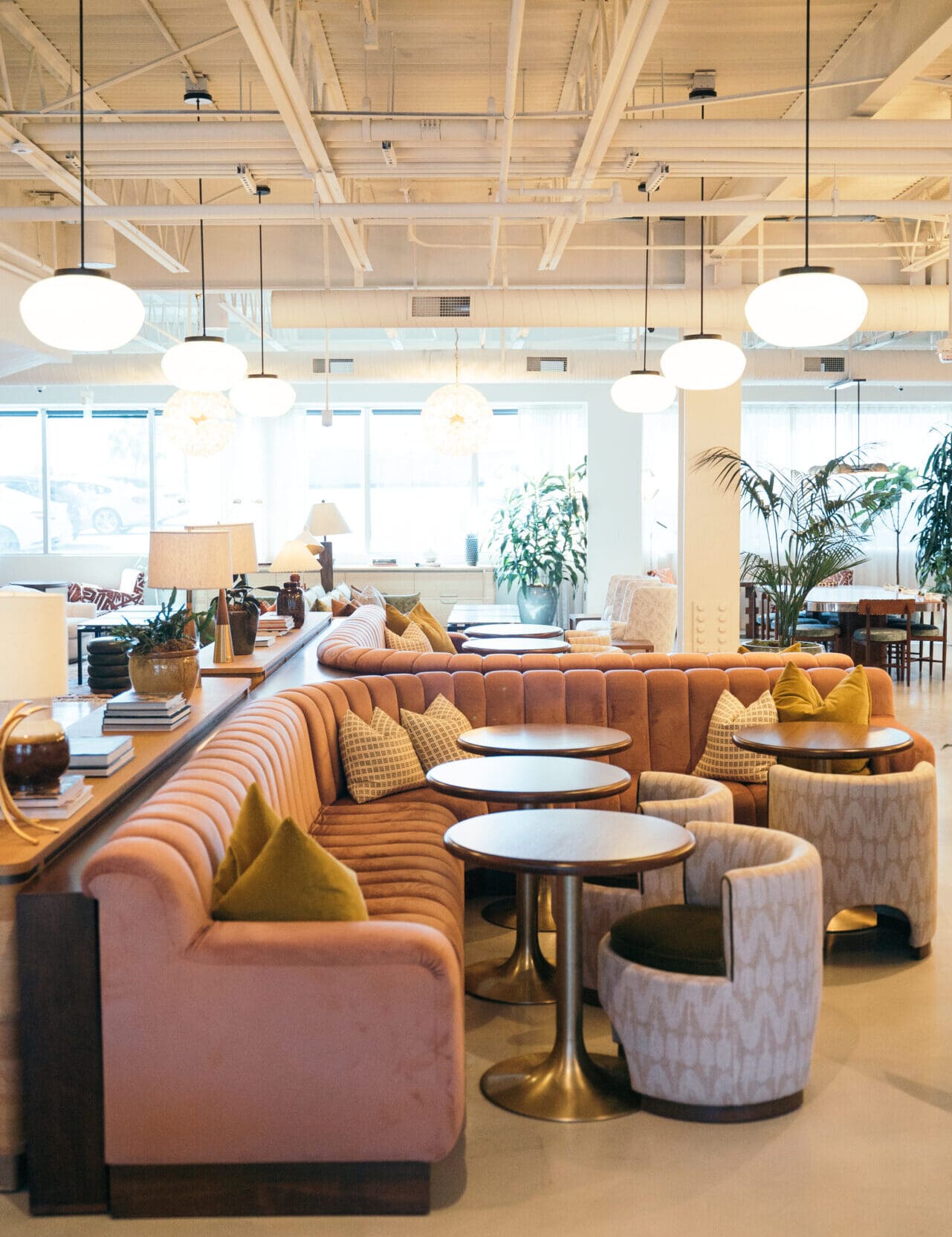 A pink sofa beneath an industrial ceiling, interiors at Soho Works, Los Angeles