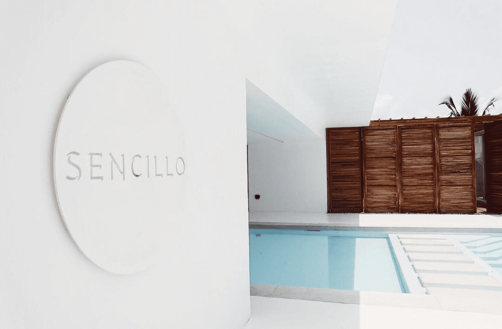 The best hotels in Lagos, Nigeria | the white wall exterior at Sencillo Lagos, with a swimming pool in view
