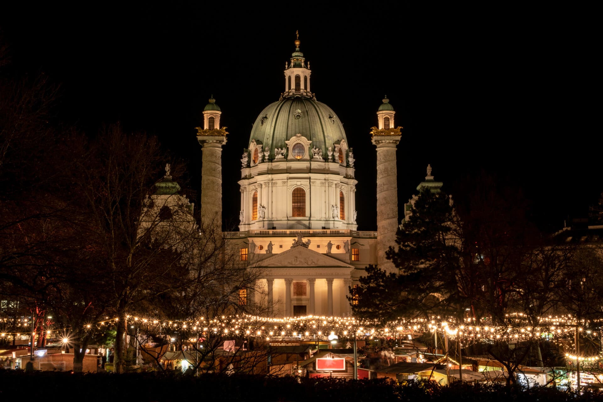 The best Christmas markets in Europe | a historic domed building lit up at night in Vienna